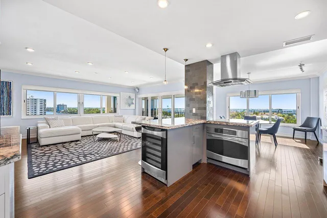 a kitchen with stainless steel appliances granite countertop a stove and a wooden floors