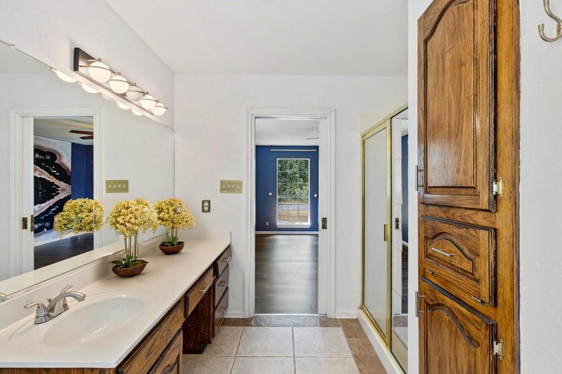 2412 Jones Road Austin, TX 78745 - Photo 12 of 40 a bathroom with a sink and a mirror