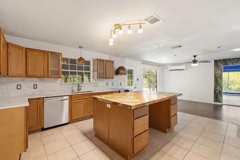 a kitchen with stainless steel appliances a sink stove and cabinets