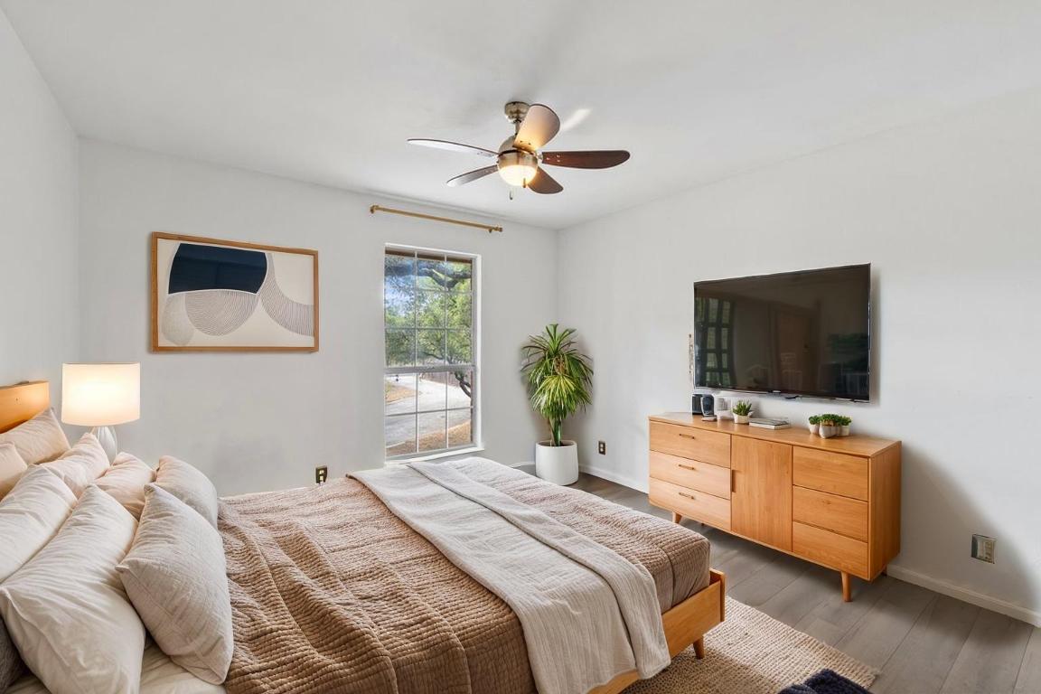 2412 Jones Road Austin, TX 78745 - Photo 19 of 40 a bedroom with a bed and a flat screen tv