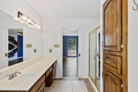 a bathroom with a double vanity sink and a mirror