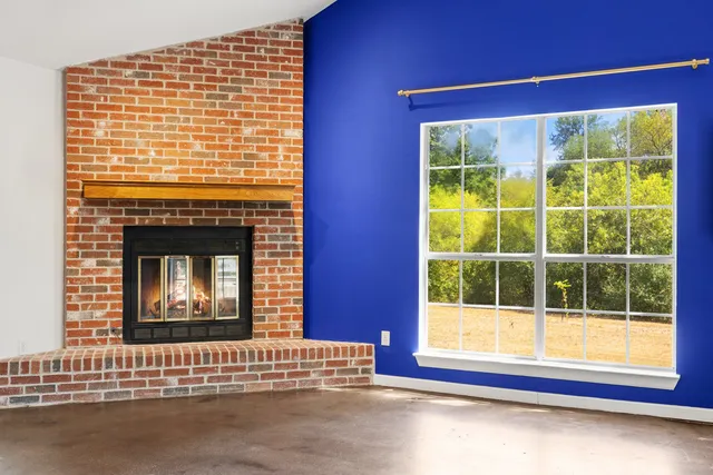 a view of an empty room with a fireplace