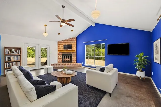 a living room with furniture potted plant and a window