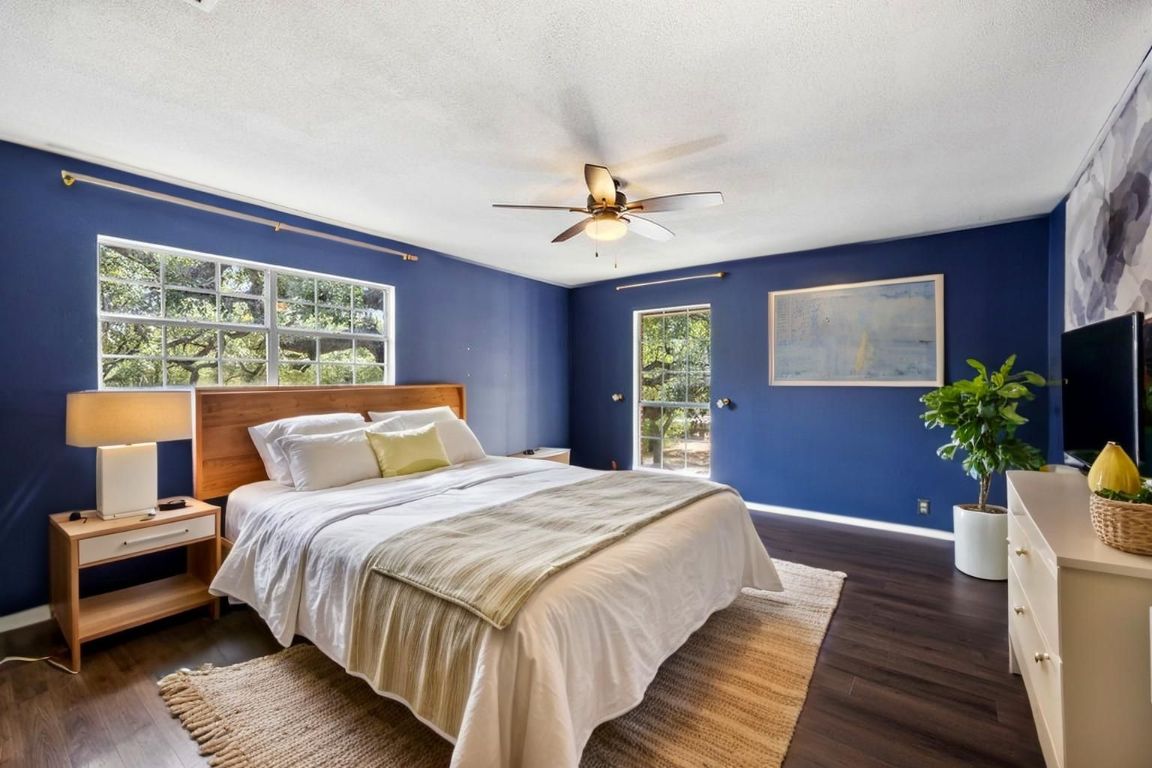 2412 Jones Road Austin, TX 78745 - Photo 10 of 40 a bedroom with double bed and a potted plant