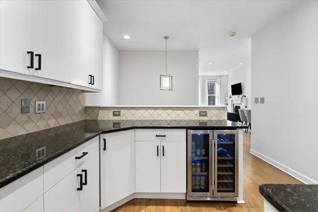 a kitchen with granite countertop a sink and cabinets