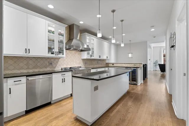 a kitchen with stainless steel appliances granite countertop a sink and a stove top oven