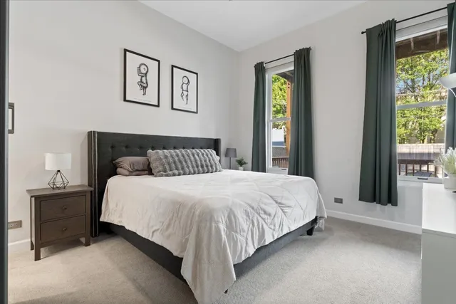 a bedroom with a bed and painting on the wall