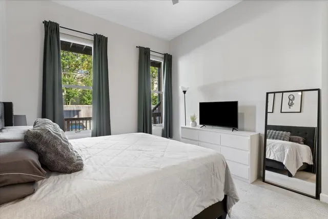 a bedroom with a bed and a television