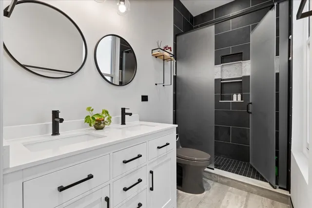 a bathroom with a sink a toilet and a mirror