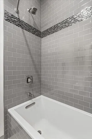 a bathroom with a bathtub and shower