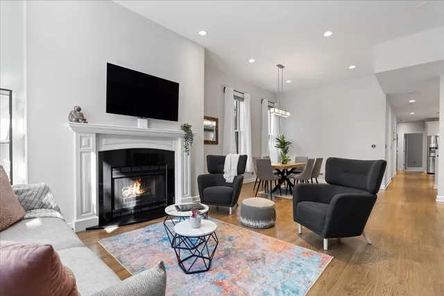 a living room with furniture a flat screen tv and a fireplace