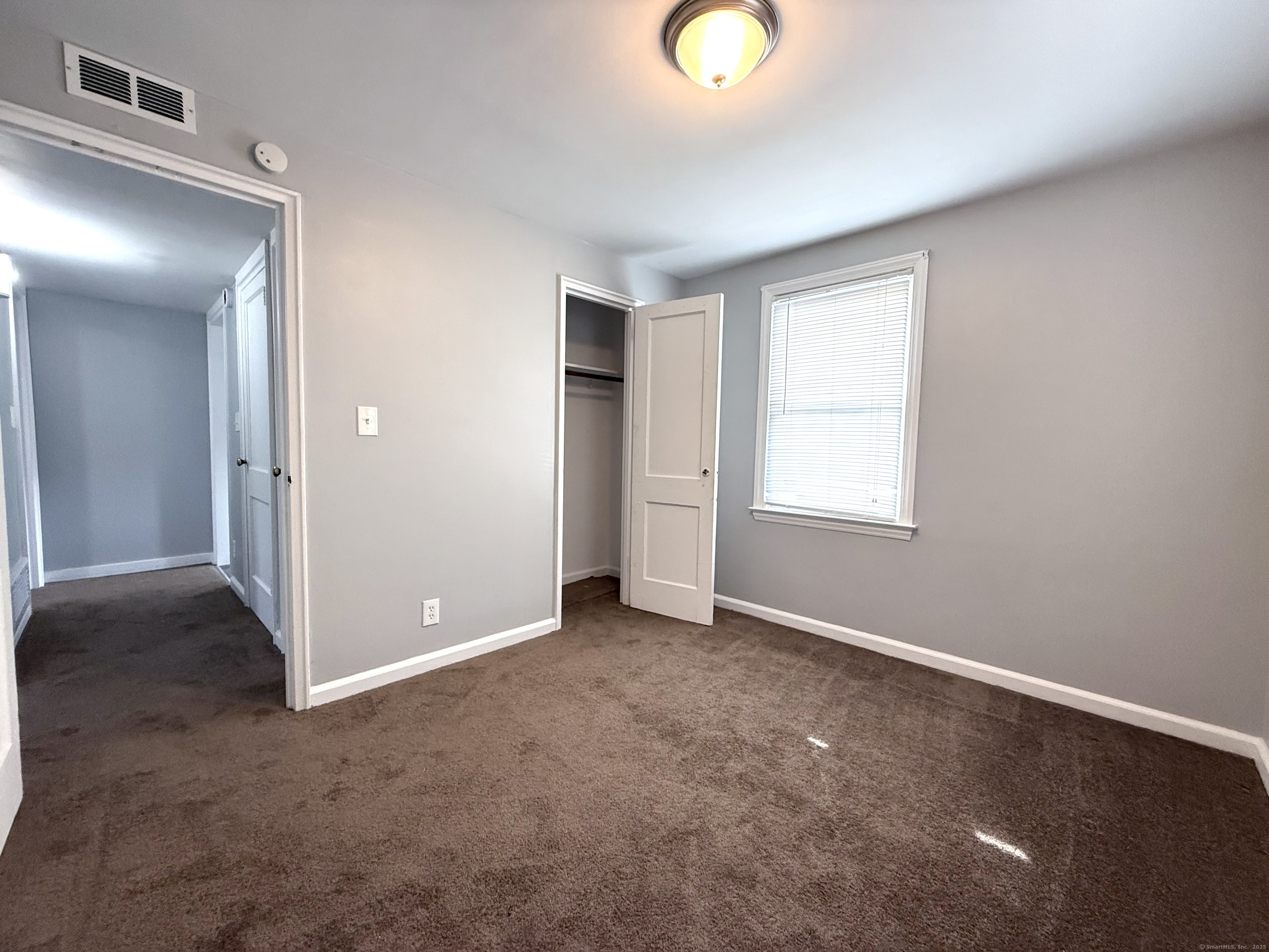 211 Spencer Street Naugatuck, CT 06770 - Photo 14 of 25 an empty room with windows and closet