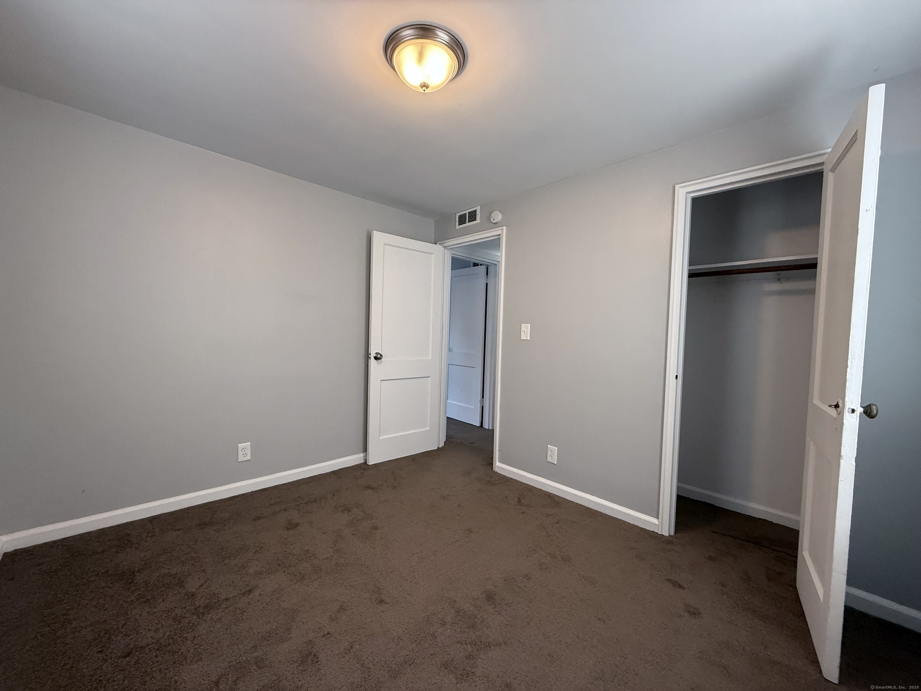 211 Spencer Street Naugatuck, CT 06770 - Photo 15 of 25 an empty room with closet and windows