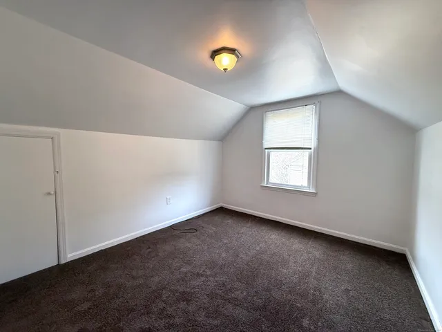 an empty room with a window and a ceiling fan
