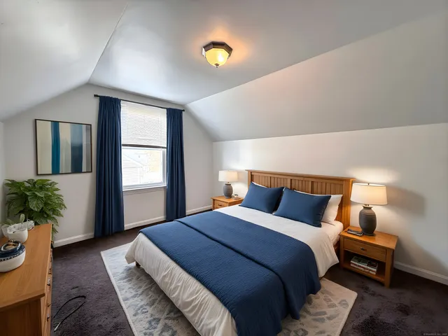 a bedroom with bed and a potted plant