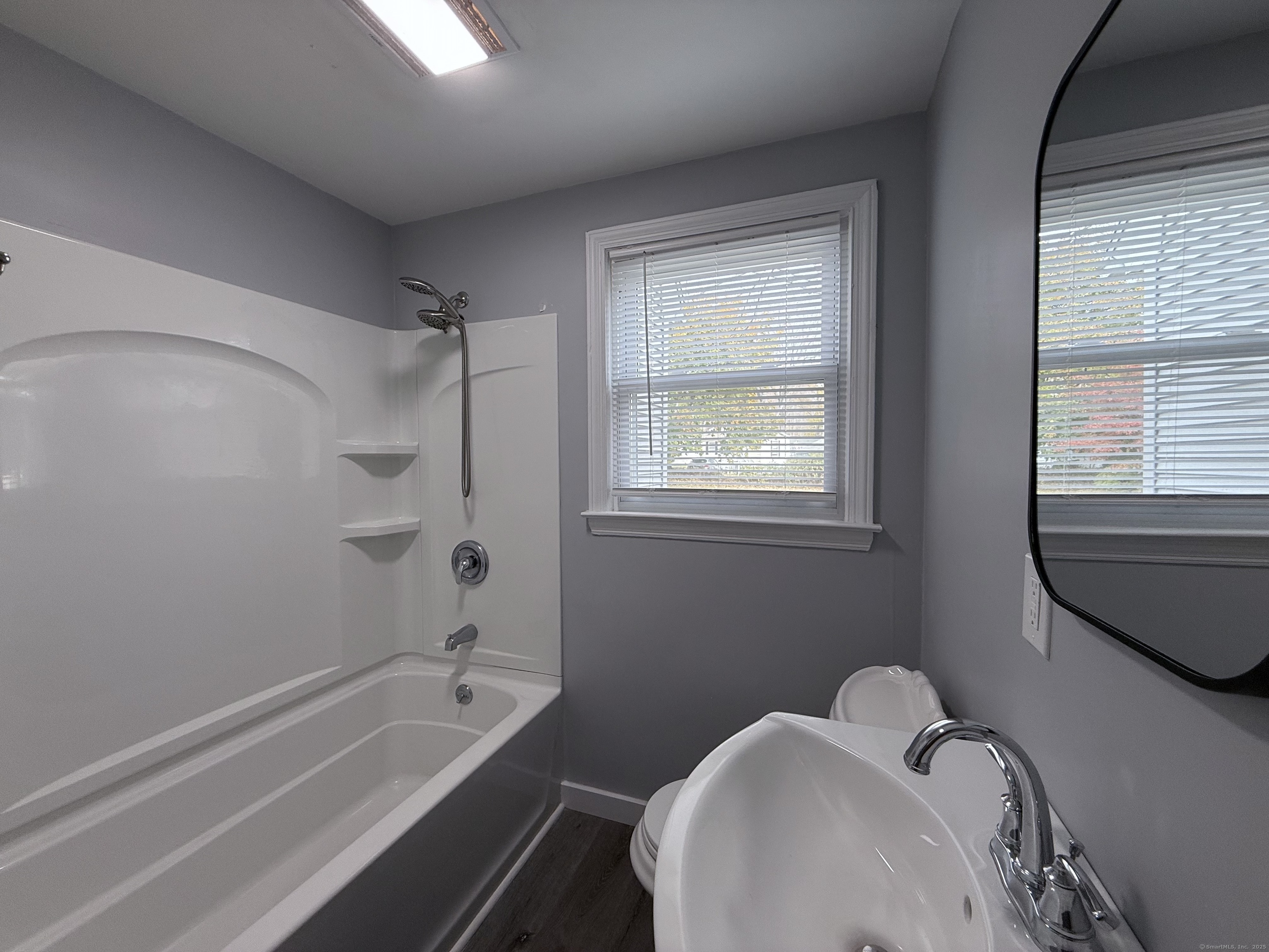 211 Spencer Street Naugatuck, CT 06770 - Photo 10 of 25 a bathroom with a tub sink and mirror