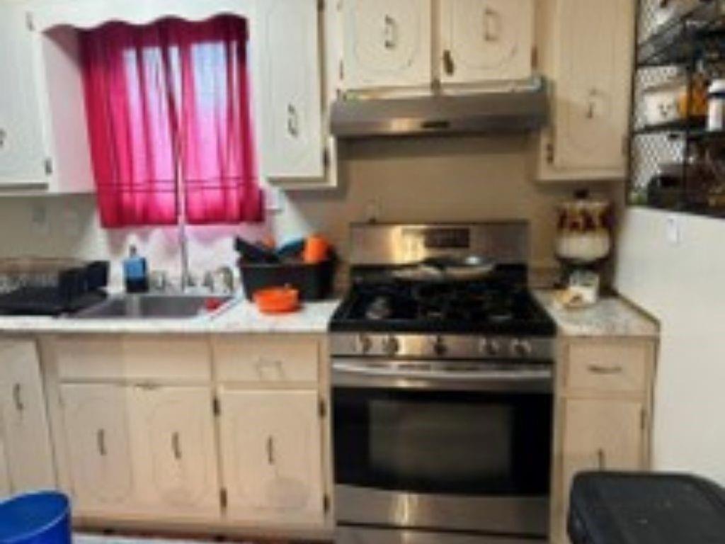 1120 Beverly Road McKeesport, PA 15133 - Photo 5 of 12 a kitchen with stainless steel appliances granite countertop a stove and a microwave