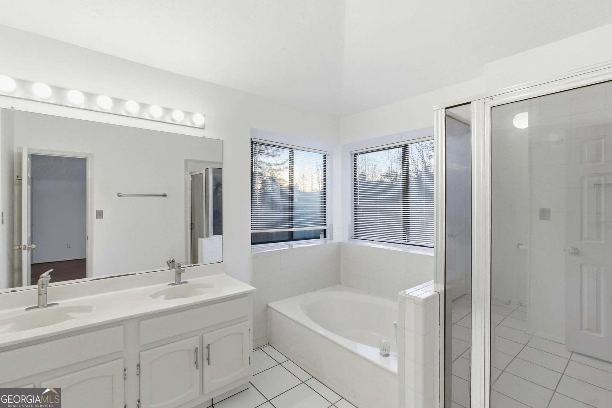 523 North Shore Road Lithonia, GA 30058 - Photo 16 of 26 a bathroom with a tub sink and mirror