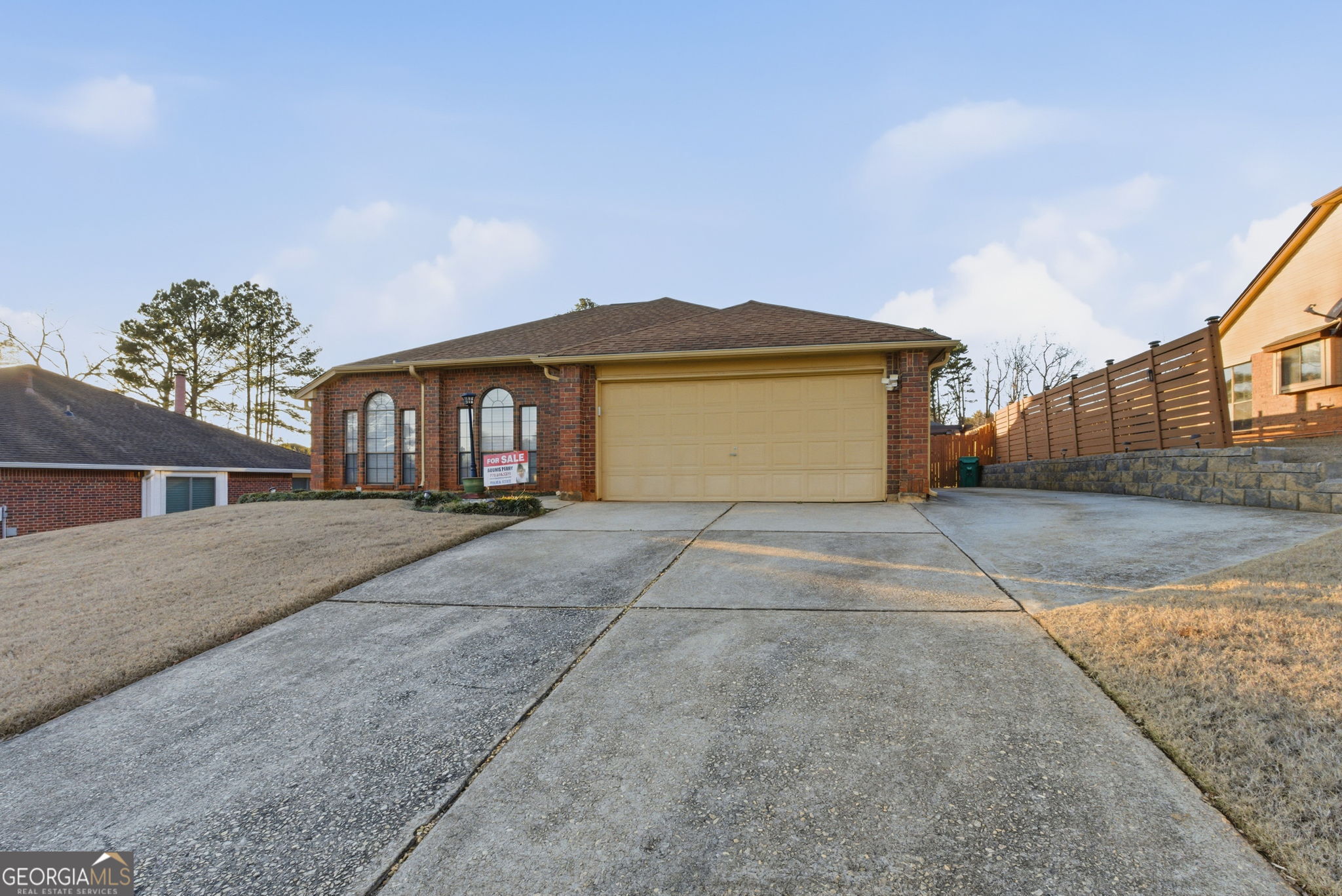 523 North Shore Road Lithonia, GA 30058 - Photo 2 of 26 a front view of a house with a yard and garage