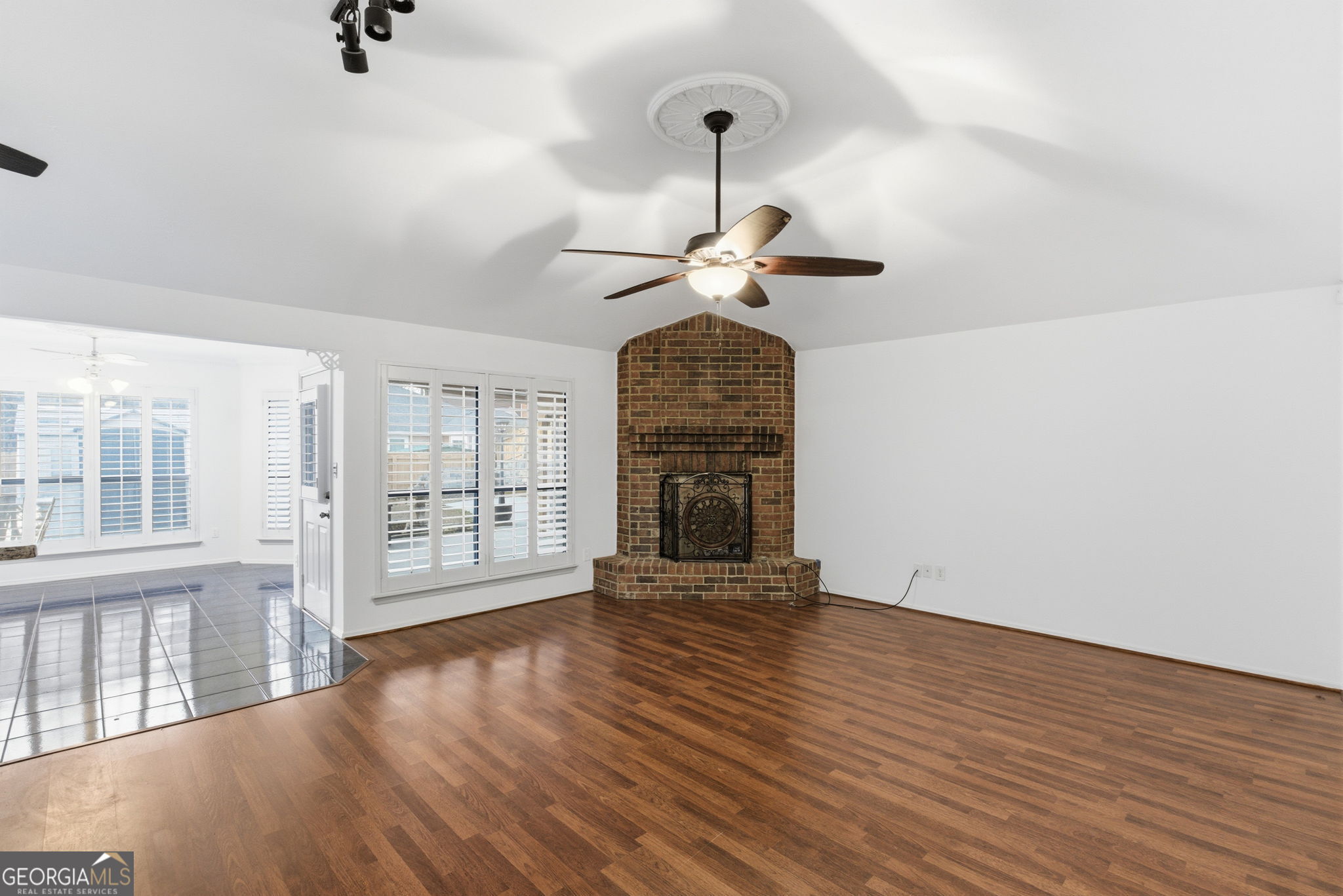 523 North Shore Road Lithonia, GA 30058 - Photo 4 of 26 a view of an empty room with wooden floor fireplace and a window