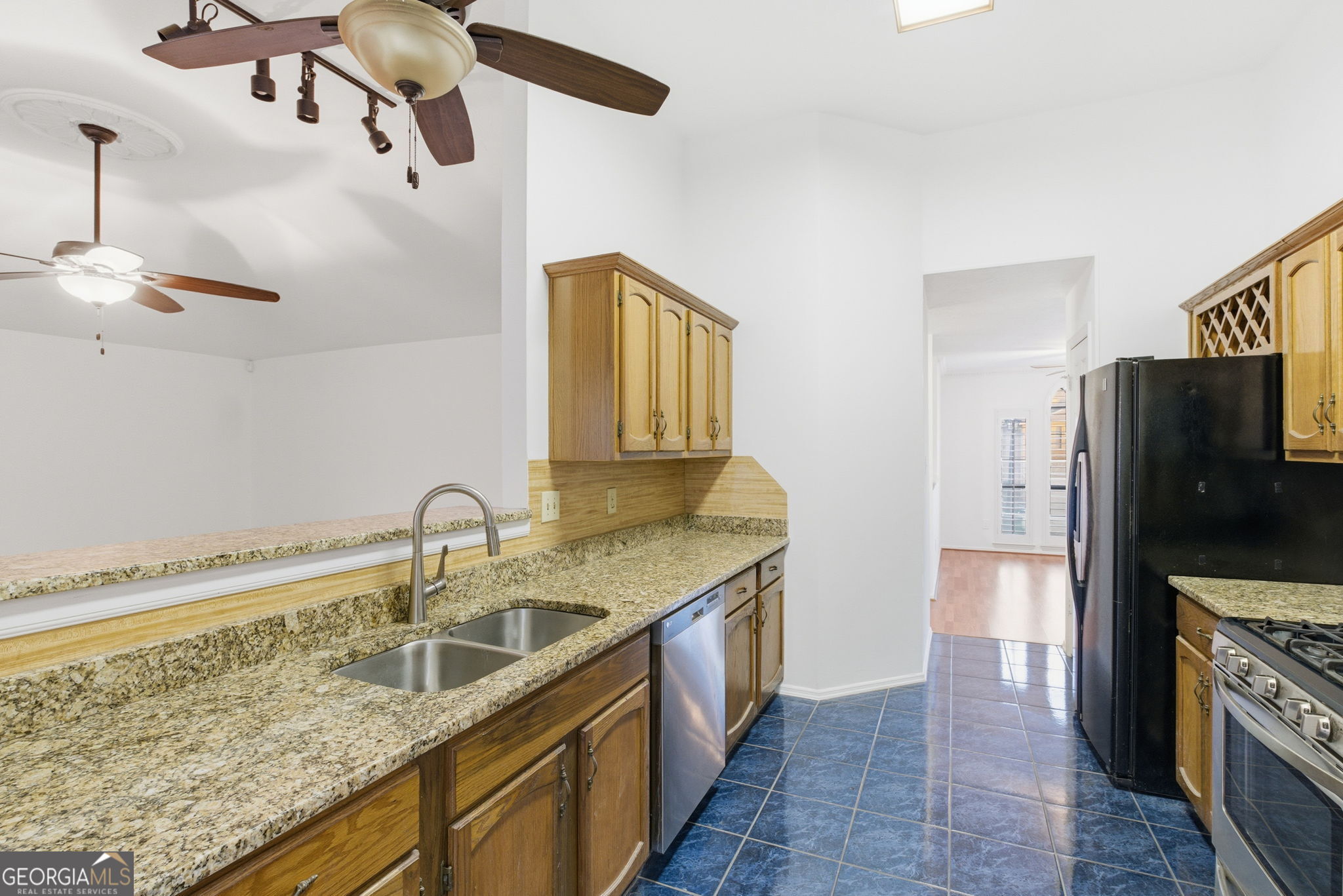 523 North Shore Road Lithonia, GA 30058 - Photo 8 of 26 a kitchen with a sink stove and refrigerator