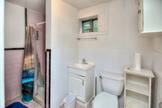 a white toilet sitting next to a bathroom sink