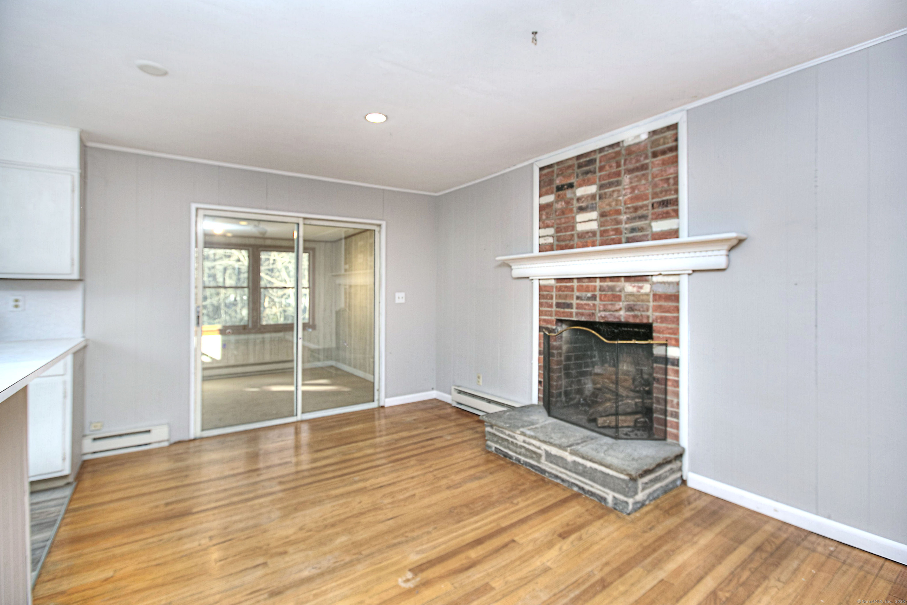 489 Main Street Westport, CT 06880 - Photo 7 of 40 a view of an empty room with wooden floor and a window