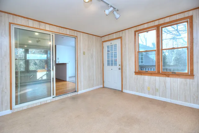 an empty room that has a view of windows