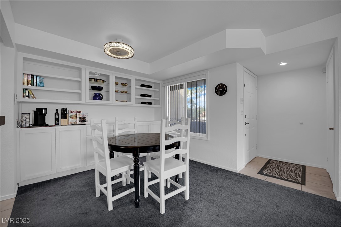 1909 Mountain Hills Court, Unit 205 Las Vegas, NV 89128 - Photo 13 of 34 Dining space with light colored carpet and light tile patterned floors
