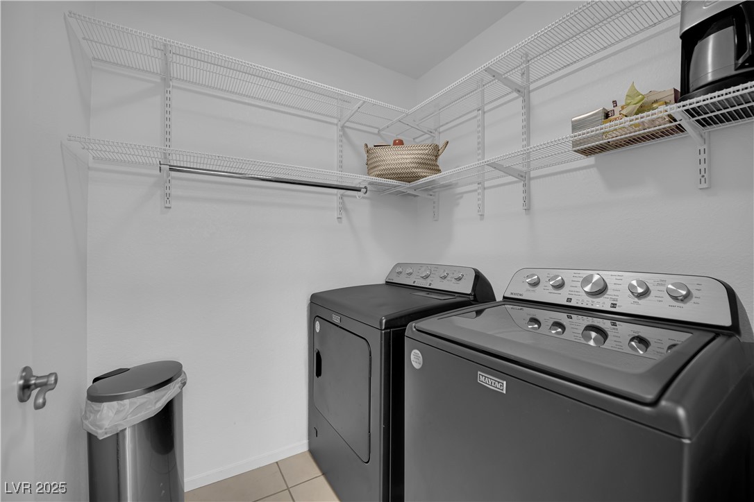 1909 Mountain Hills Court, Unit 205 Las Vegas, NV 89128 - Photo 21 of 34 Laundry area with separate washer and dryer and light tile patterned floors