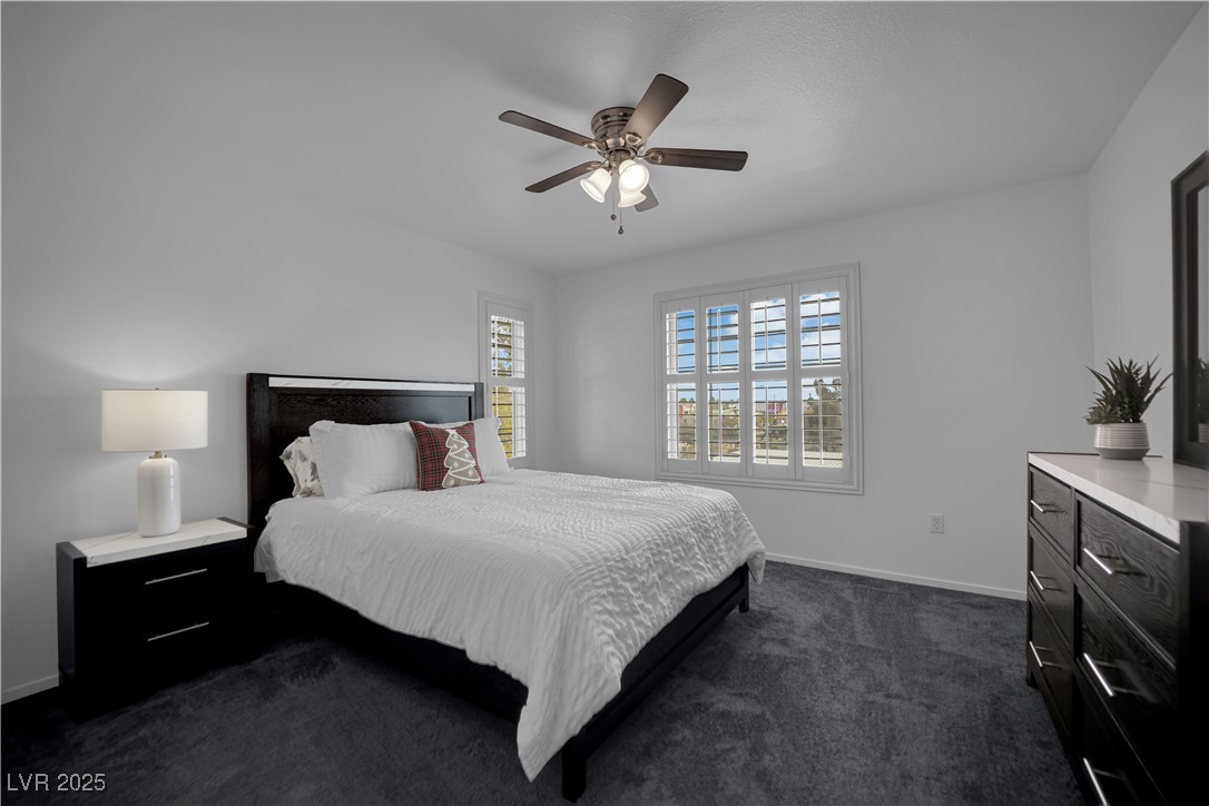 1909 Mountain Hills Court, Unit 205 Las Vegas, NV 89128 - Photo 22 of 34 Bedroom with dark carpet and ceiling fan