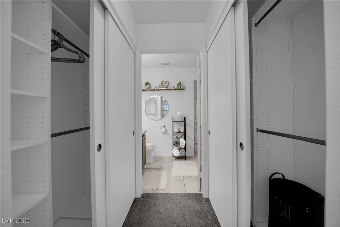 1909 Mountain Hills Court, Unit 205 Las Vegas, NV 89128 - Photo 25 of 34 Hall with tile patterned floors and carpet flooring