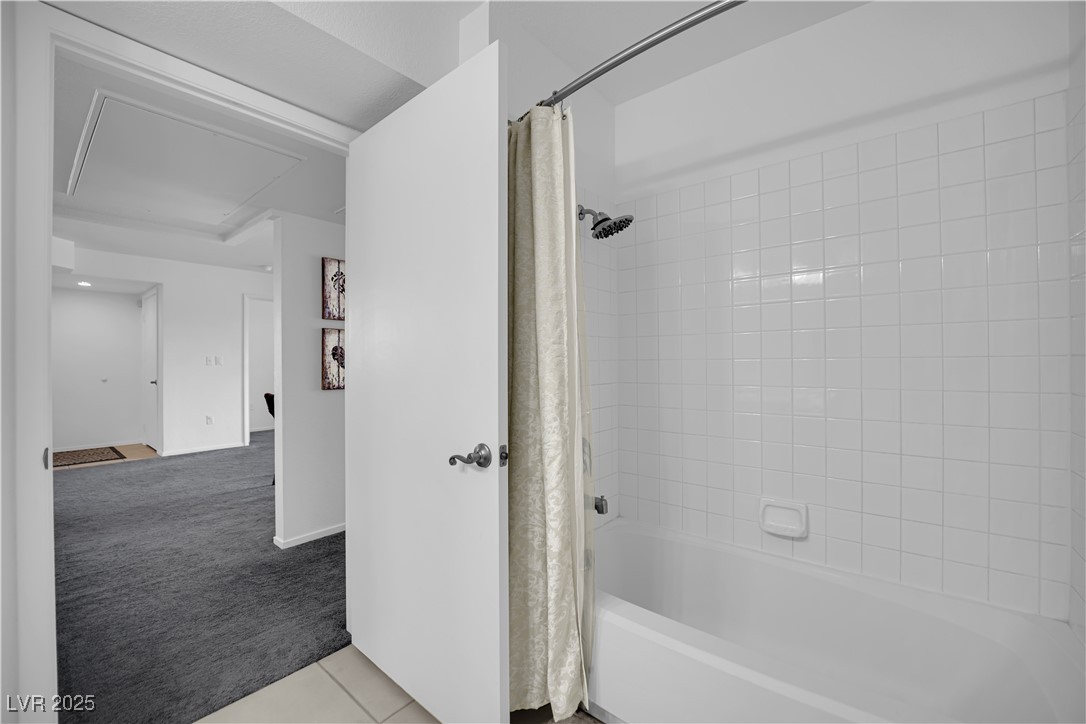 1909 Mountain Hills Court, Unit 205 Las Vegas, NV 89128 - Photo 29 of 34 Full bath featuring light carpet, shower / tub combo, and light tile patterned floors