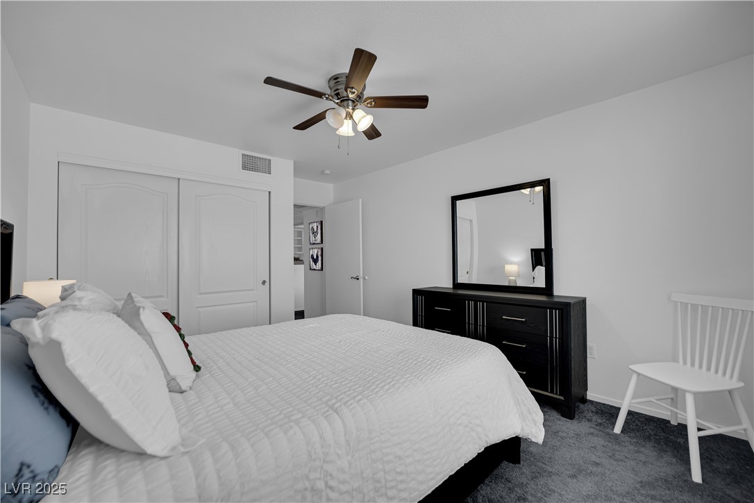 1909 Mountain Hills Court, Unit 205 Las Vegas, NV 89128 - Photo 31 of 34 Bedroom with dark carpet, ceiling fan, and a closet