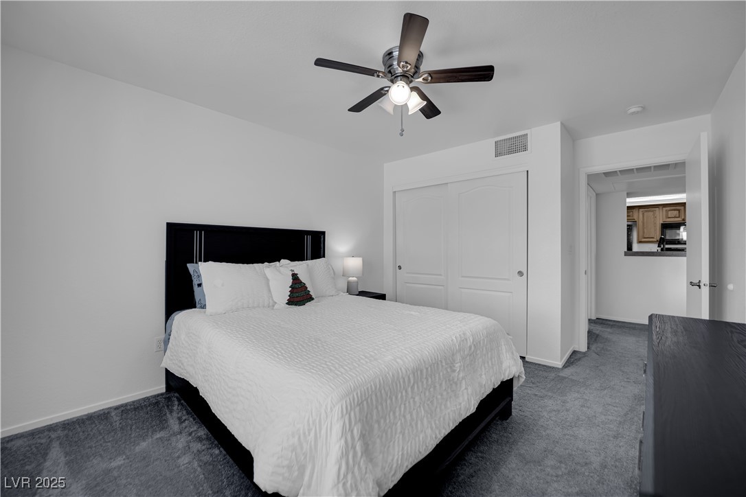 1909 Mountain Hills Court, Unit 205 Las Vegas, NV 89128 - Photo 32 of 34 Carpeted bedroom featuring ceiling fan and a closet