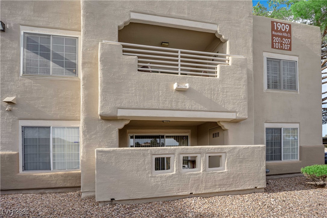 1909 Mountain Hills Court, Unit 205 Las Vegas, NV 89128 - Photo 4 of 34 Rear view of property with stucco siding