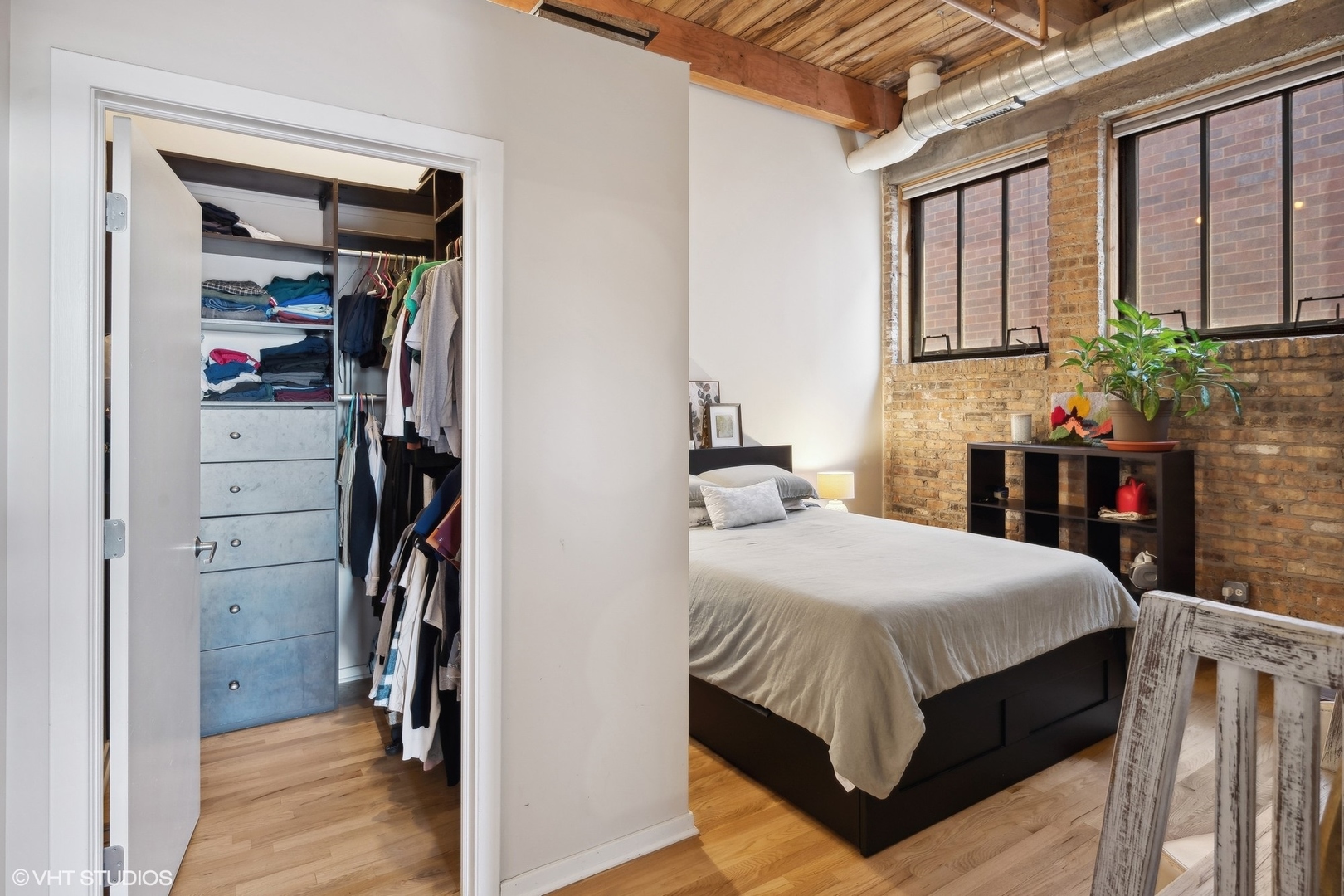 1040 West Adams Street, Unit 601 Chicago, IL 60607 - Photo 11 of 13 a bedroom with a bed and a table