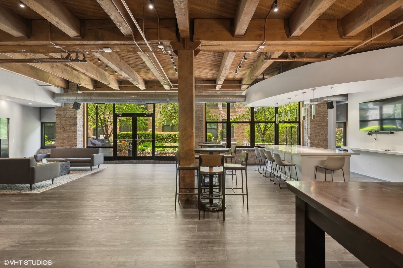 1040 West Adams Street, Unit 601 Chicago, IL 60607 - Photo 13 of 13 a dining hall with couches a dining table and chairs with outer view