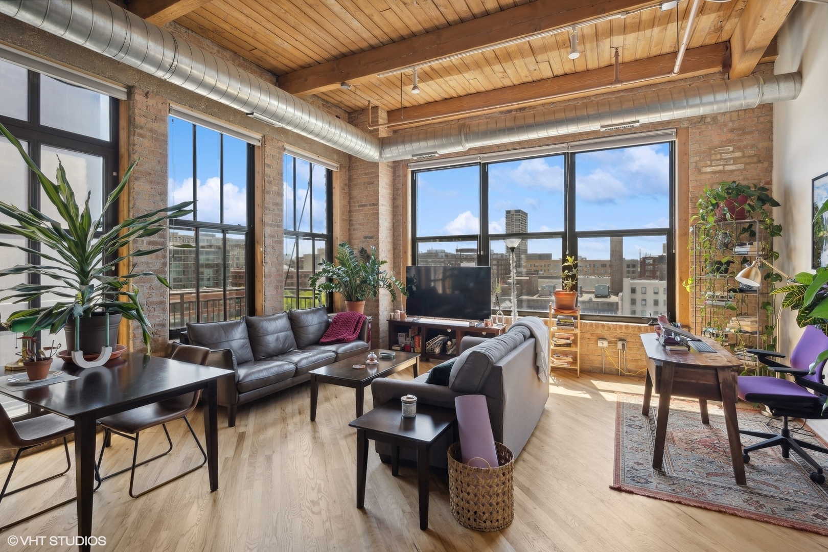 1040 West Adams Street, Unit 601 Chicago, IL 60607 - Photo 2 of 13 a living room with furniture tv and wooden floor