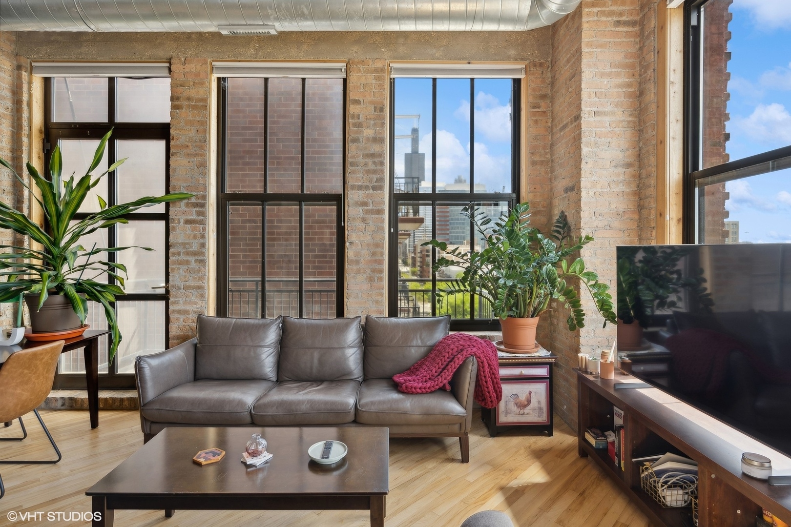 1040 West Adams Street, Unit 601 Chicago, IL 60607 - Photo 3 of 13 a living room with furniture and a floor to ceiling window