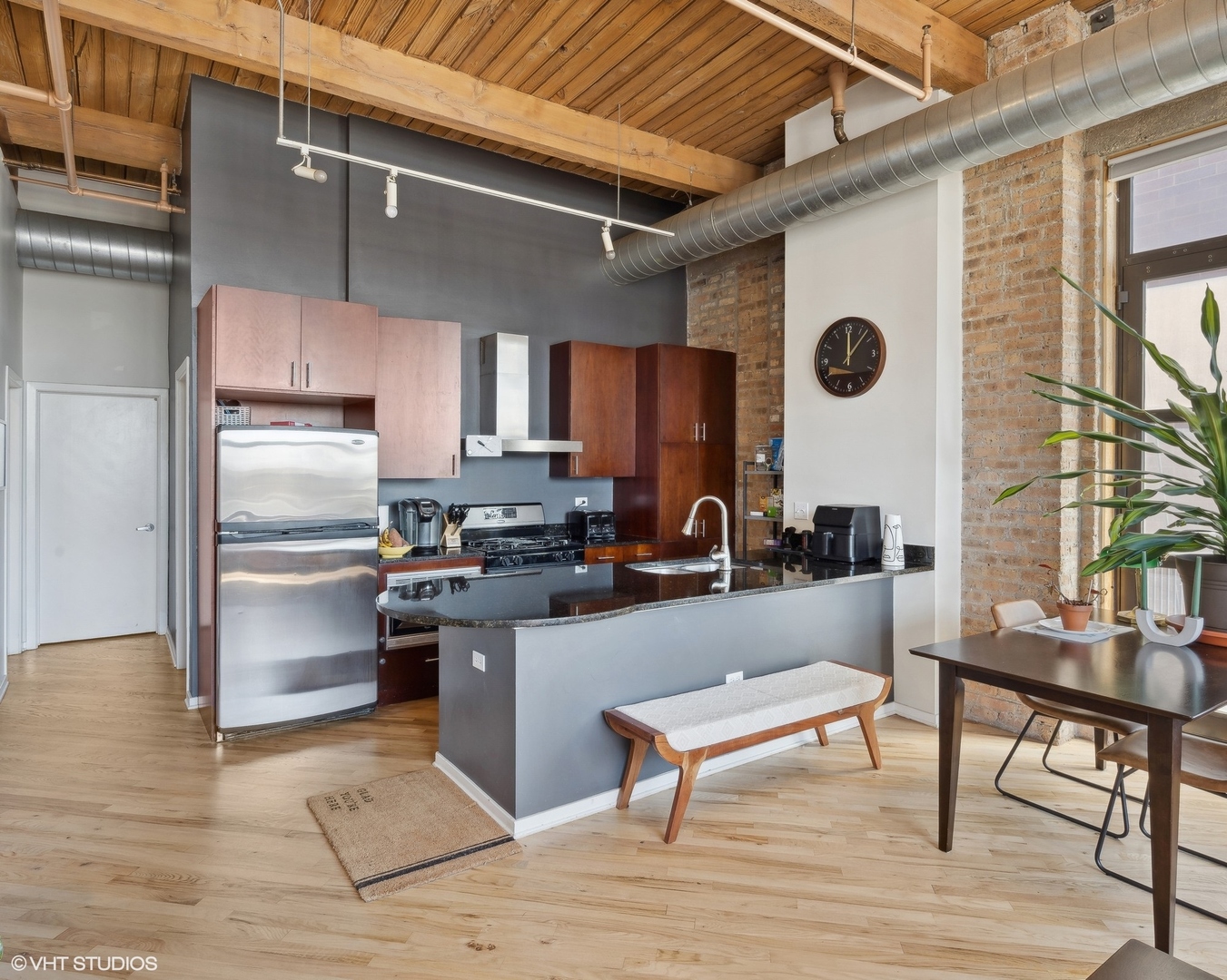 1040 West Adams Street, Unit 601 Chicago, IL 60607 - Photo 6 of 13 a kitchen with stainless steel appliances refrigerator wooden floor and cabinets