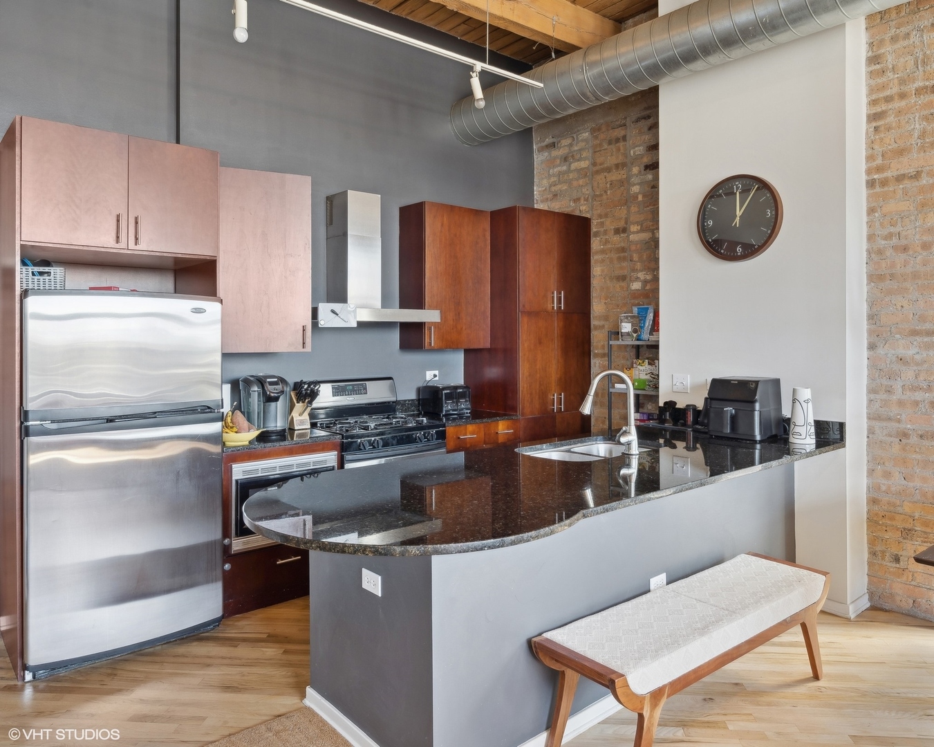 1040 West Adams Street, Unit 601 Chicago, IL 60607 - Photo 7 of 13 a kitchen with stainless steel appliances granite countertop a refrigerator a stove top oven a sink and dishwasher