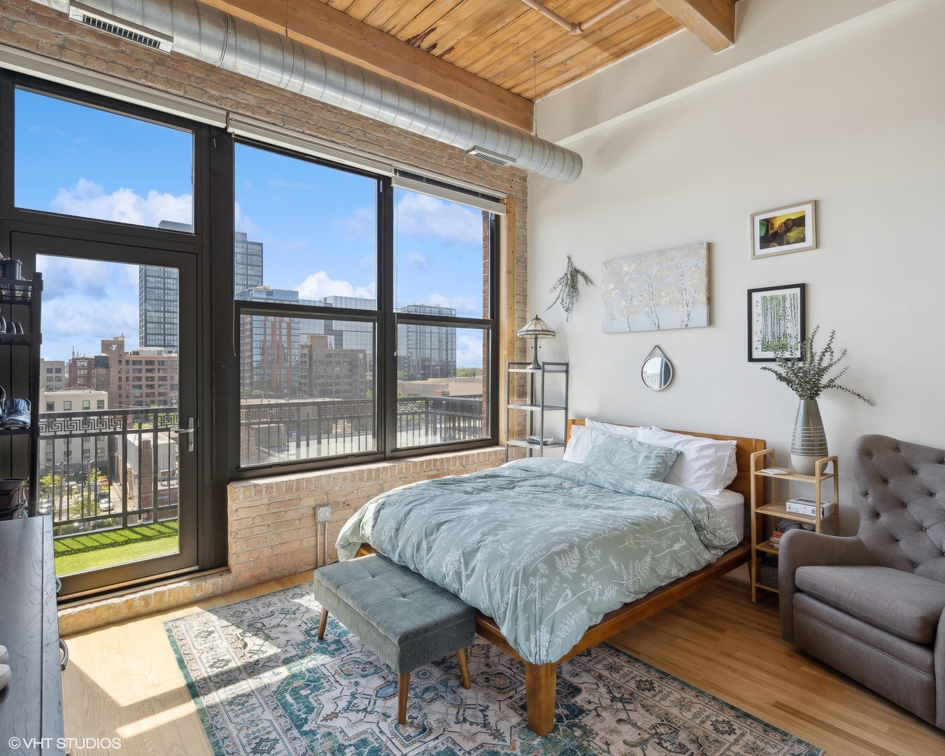 1040 West Adams Street, Unit 601 Chicago, IL 60607 - Photo 8 of 13 a bedroom with a bed and wooden floor