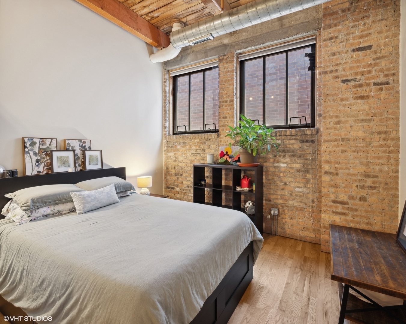 1040 West Adams Street, Unit 601 Chicago, IL 60607 - Photo 10 of 13 a bedroom with a bed and a table