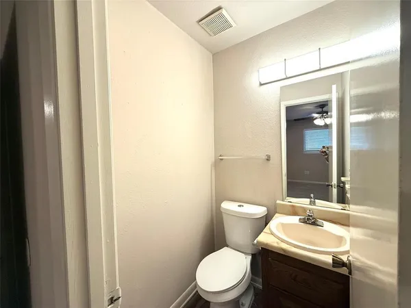 a bathroom with a sink a toilet a mirror and shower