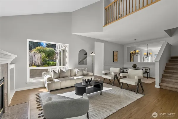a living room with furniture fireplace and a large window