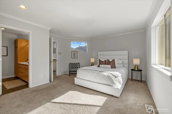 a spacious bedroom with a bed and a window