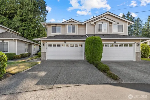 a view of house with outdoor space and view of a house