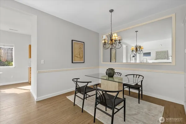 a view of a dining room with furniture wooden floor and chandelier