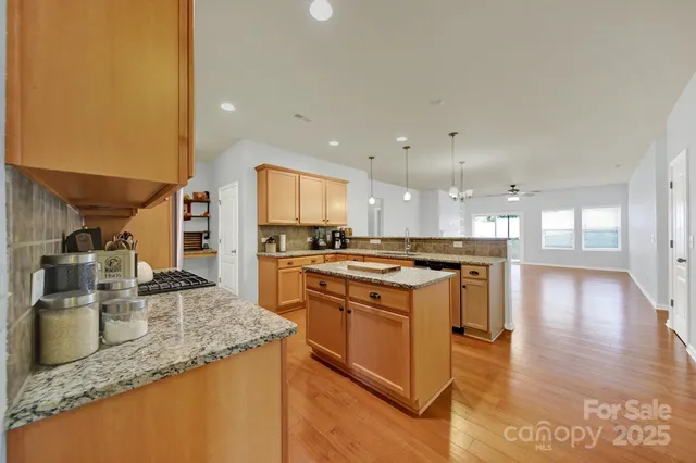 a kitchen with a sink a counter top space and stainless steel appliances